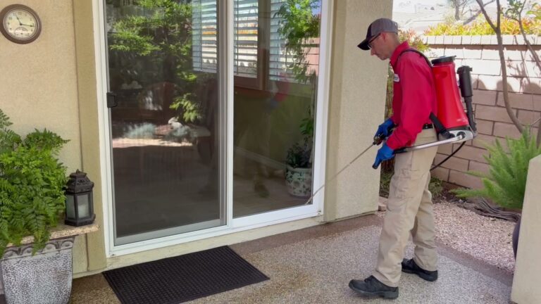 Bull’s Eye Pest Control technician treating around a patio door